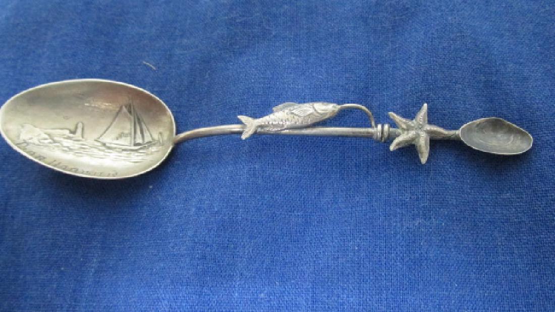 Bar Harbor Maine Sterling Spoon: Unusual theme with sail boats in the bowl of the spoon, fish with star and oyster shell on the handle, sterling, probably 1910-20, 3 3/4" long. Bar Harbor with a sail boat and light house is in the ce