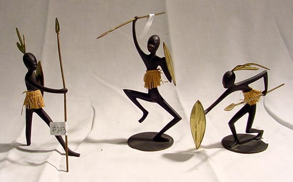 Hagenauer Wien Bronze Tribal Figures: High end Austrian collectables from Hagenauer showing tribal men with spears, shields in brass, aged bronze body, grass skirts, likely to be from 1970s or 80s. Of the 3, one has a base and foot broken