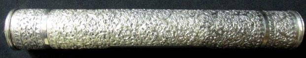 Anglo Indian 1911 Silver Scroll Cylinder: Raj Period of India, Presented in 1911 to J. Moore, Esq., by the European Staff, Clerks and Workpeople of The Bombay Woolen Mills, with the original presentation scroll inside. Carved, chased and