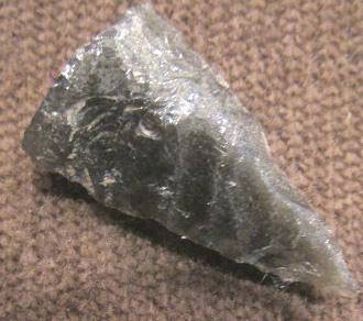 Pre-Columbian Flint/Obsidian Arrow Head: By 1958, the owner remembers this in the family home. From 500-1500 years old, likely Mexican, either flint or obsidian, sharp arrowhead that is in excellent condition, only possible missing piece is