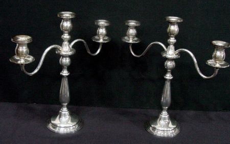 Pair Of Sterling Silver Candelabra: Weighted Bases. 2 Piece Construction. 14" High, Arms Reach 13 1/4". Single Candlestick Is 9 3/4" High. The arms screw out and can be used as single sticks or the candelabra.