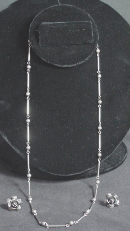 3 Pc. Silver Necklace And Earrings: Sterling silver necklace with round beads and long square tubing, signed Mexico, 24" long, excellent condition, 2 sterling silver floral theme screw back earrings, all from the 1950s.