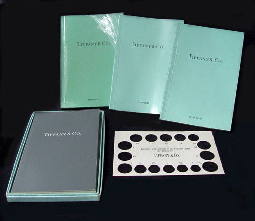 A Collection of 1960s & 1970s Tiffany & Co. Catalo: Trademark blue exteriors, great reference materials showing Tiffany creations in the mid 60s to the early 70s. Original box for oldest catalogue that also holds a Tiffany ring sizer in cardboard. Tota