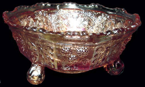 A Panther & Butterfly Orange Carnival Glass Bowl: 190-1920, unmarked interior showing 2 panthers? With leaves and berries of some sort, exterior shows blackberries? And butterflies, 3 claw feet, good condition. 5" wide by 2 1/4" tall.
