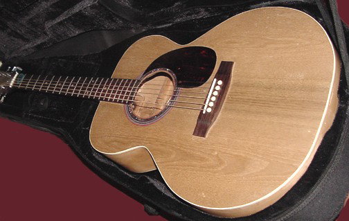 An Assembled Guitar w/6 Strings: A Gibson neck, a Sassafras top, Birds Eye Maple back, sides appear to be Maple, assembled by Glenn Sluss, Gate City, Va., in 1999 and a note inside the 6 string guitar states that he is an Instrument