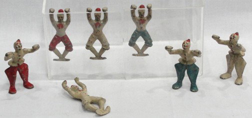Cast Iron Circus Clown Figures: Set of 7, red and blue paints, white tops, all painted faces and wearing hats, 2 3/4" tall, 3 are to be free standing, 4 are designed to hang on a wire or vehicle or flat side of some sort. No makers