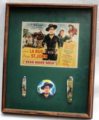 Lash LaRue Dead Man's Gold Poster: Framed poster or lobby card from Dead Man's Gold starring Lash LaRue and Fuzzy St. John, autographed by Lash LaRue in 1992 to a fan. Show box frame includes 2 knives, 1 round button and the lobby card