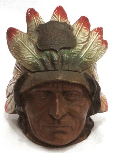 Cold Painted Victorian Indian Inkwell: From Saratoga, NY, crest on top center of headdress, flip hinged top with original glass inkwell, showing colored feathers, brown or red face of the Indian, 4" tall by 3 1/2" wide. Excellent original