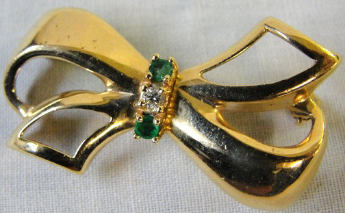 A 14K Bow Brooch w/Diamond & Emeralds: Mrs. White of The Wellesley Inn On The Square in Wellesley, Mass., was a jewelry collector in a very tasteful manner. This bow broach is 14K yellow gold and has a center diamond that is .03 carats of