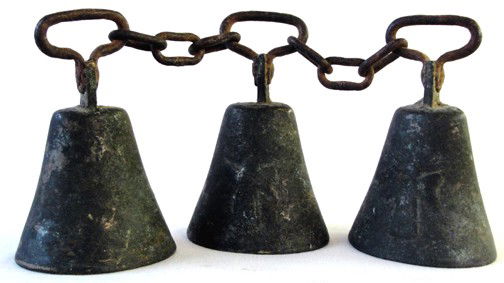 A Set of 3 Animal Brass Bells: Probably used for either a donkey, burrow or large goat, these 3 brass bells are hand made, late 19th century and have a melodious sound. Iron handles are connected by a chain. 4" tall by 2 1/2" wide