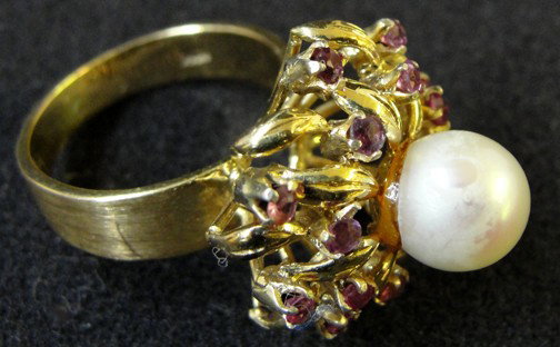 An 18K Garnet & Pearl Ladies Ring: Mrs. White of the Wellesley Inn on the Square in Wellesley, Mass., wore this pearl and garnet ring on a regular basis. The center pearl is surrounded by 18 approximately .05 carat garnets that are of