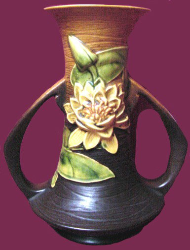 A Roseville Water Lilly Vase: Marked Roseville 80-10, this Water Lilly pattern vase is in good condition, measures some 10" tall by 8" from handle to handle.