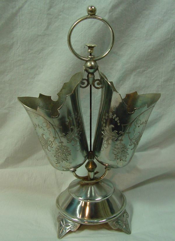 A Victorian Silver Plated Bell & Pr. Vases: Renaissance Revival era, dated 1875 on base, center press button for the bell in the base and 2 engraved side holders for flowers or arrangements. Engraved 4 feet, 10 1/2" tall by 6 1/2" wide. Silver
