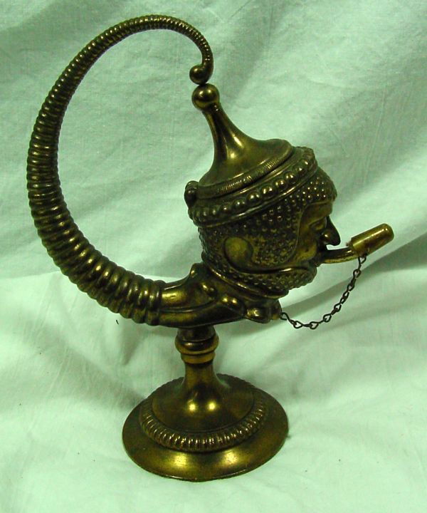 A 1920s Cigar Lighter Anglo/Indian: No makers marking, either brass or extremely heavily brass plated, showing a figure with a hinged headdress and lighter coming out of his mouth, 6 1/2" tall by 4 1/2" wide. Probably 1920s era, this re