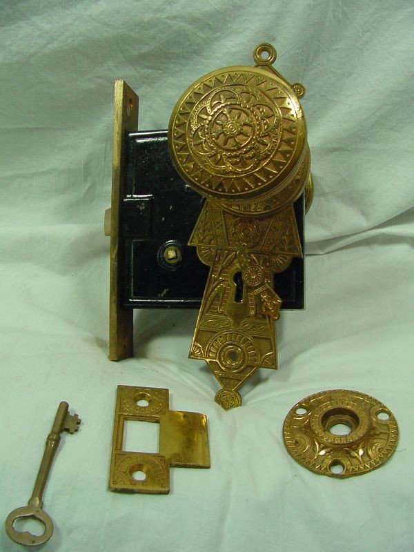 A Victorian Ornate Brass Mortar Door Lock: Last Patent date of 1873, even the original brass door key, front ornate panel with unbelievable knob, striker plate and back smaller knob with back plate. Even the Turn screw is intact. All original 