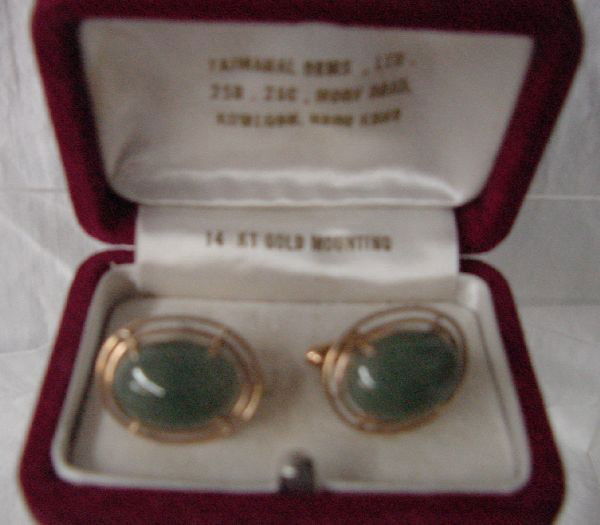 A 14K Chinese Jade Cuff Link Set: Purchased in Hong Kong in the 1960s, this oval cabochon Jade stone with 14K yellow gold mounting was purchased at Taj Mahal Gems, Ltd., 25B & 25 C Modry Rd., Kowloon, Hong Kong by the parents of the c
