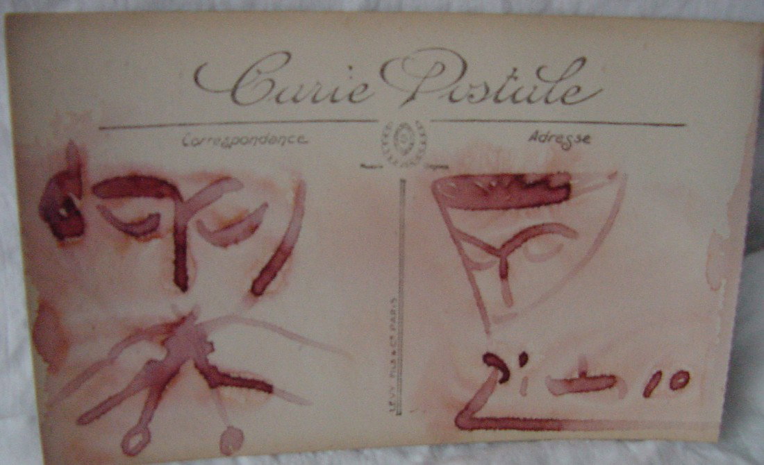 A Pablo Picasso Felt Tip Drawing: Red felt marker on a French post card, 5 1/2" wide by 3 1/4" tall, showing a face on the left perhaps playing an instrument and on the right is perhaps a theater mask. Signed lower right Picasso. Red 