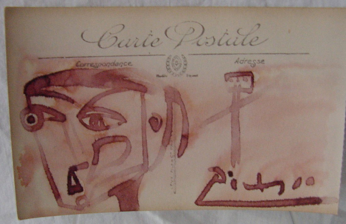 A Pablo Picasso Felt Tip Drawing: Red felt marker on a French post card, 5 1/2" wide by 3 1/4" tall, showing an abstract figure of a head on the left and a stick figure on the right. Signed Picasso in the lower right. Red wash or wate