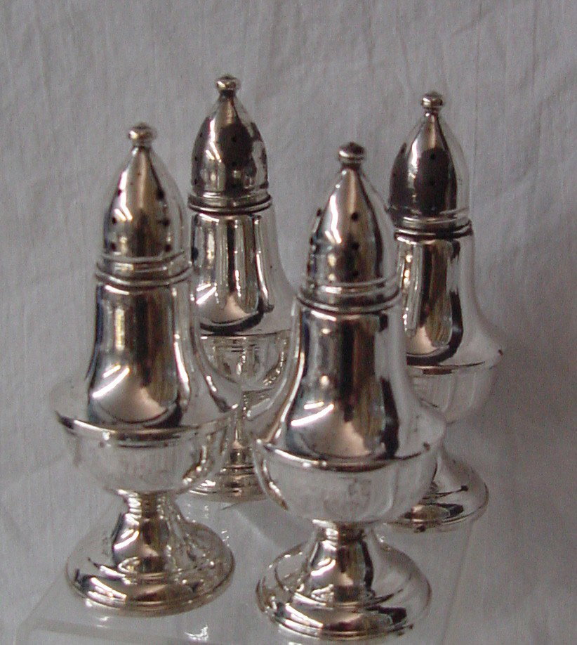 A 2 Pr Set Sterling Salt & Pepper Shakers: Classic urn shapes, 4 1/2" tall by 2 1/4" wide at the waist, Sterling markings but no makers, probably 1940s or 50s, 2 of the lids need more polish but are structurally sound. No monograms, good condi