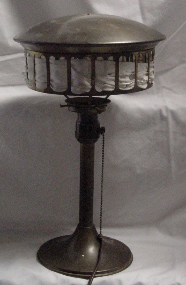 A 1904 Brass Boudoir Lamp: Either brass or bronze, original shade with cloth tape going in and out on the side band, flared base, gently sloped top, 15" tall by 9" wide, old wiring replaced years ago, patent date on the side of