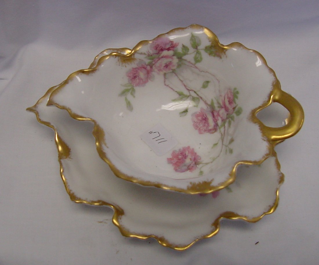 A Haviland Sauceboat & Underplate: Leaf shaped sauce boat with under plate that also is leaf shaped by Haviland, 1890-1910 era, floral design, gold trim, 7" deep by 2 1/2" tall. This is a great shaped little piece with the handle resem
