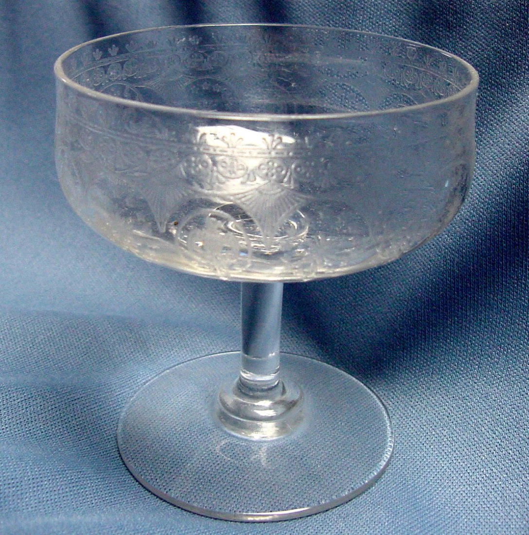 A Stylized Am. Shield Sherbet Set: 10 unsigned but high quality acid etched probably 1920s sherbets, could be used as low champagnes, 3 1/4" wide and tall, a theme of stars, American Eagle, crest, stemmed pieces. From the Estate of Che