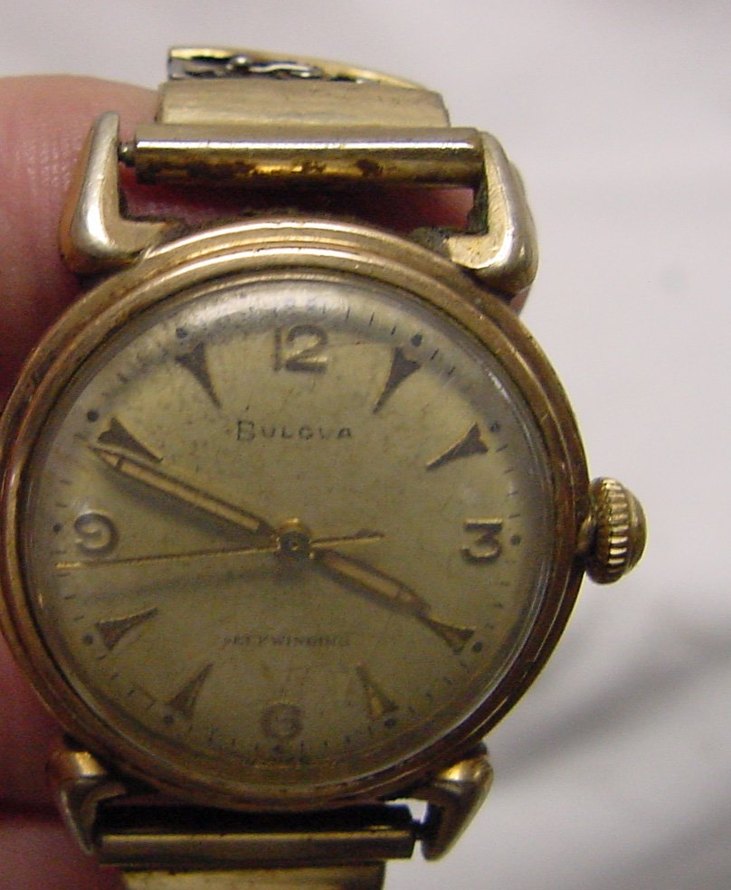 A Bulova Self Winding Wrist Watch: Bulova Swiss Self Winding, yellow gold filled case, some of the link covers are missing on the band, when I picked this up to photograph it, immediately it began running. This has sat in a safety depo