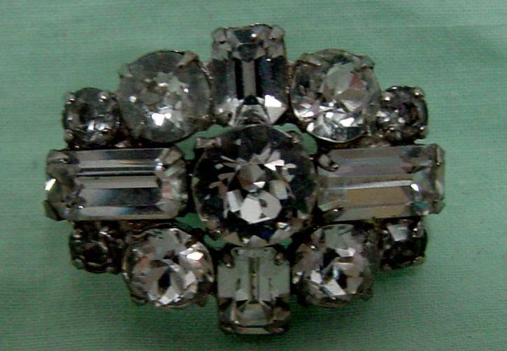 Kramer Rhinestone Retro Pin: Pure 1950s retro, Rhinestone in mint condition signed Kramer of New York, Emerald cuts, rounds and oblong stones, great visual appeal, 1 1/4" long by 3/4" wide.