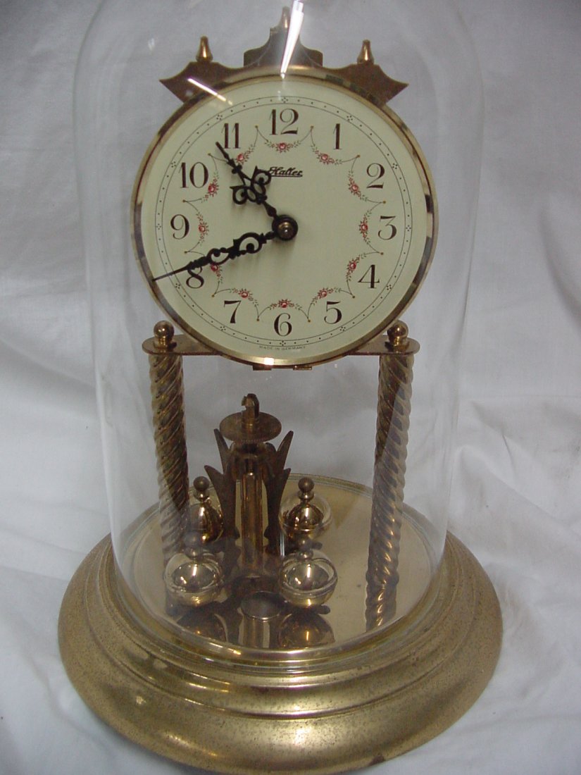 Haller German Anniversary Clock: Commonly called 400 days clocks, 8 1/2" tall, swag designs on the enamel face, seemingly all there, probably 1960s or 70s era.