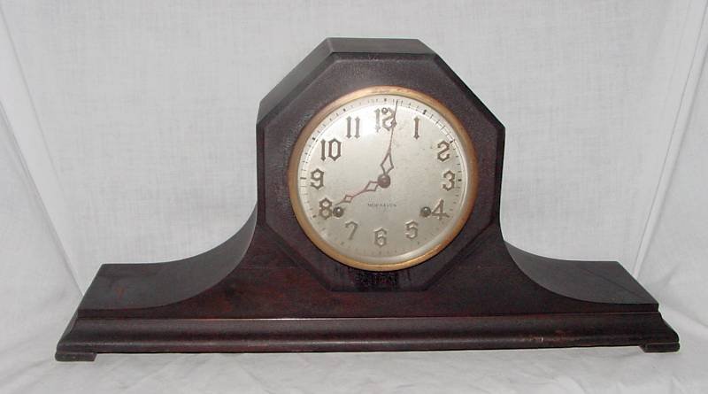 New Haven Art Deco Mantle Clock: Beveled round glass in the door, beveled front in the wood, original crazed Mahogany surface to the case, white face with gold letters, New Haven is a major maker, this is pure Art Deco from the 1920s