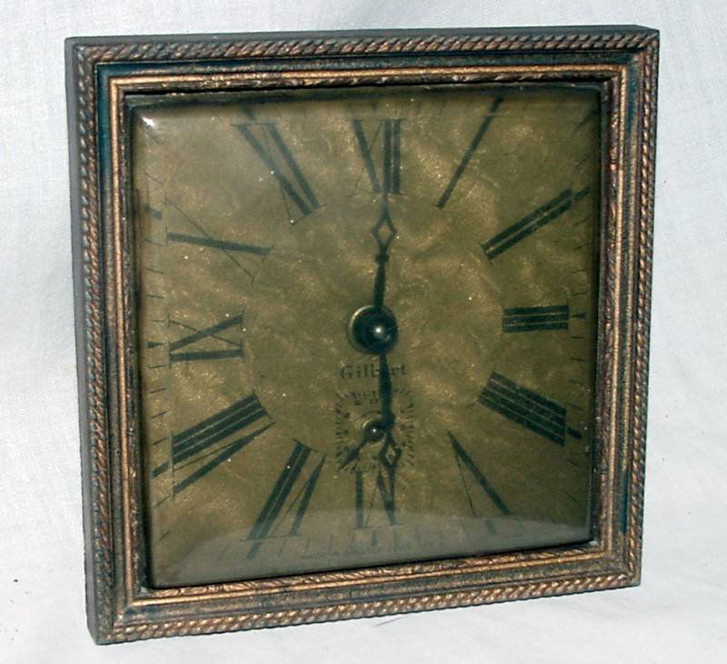 Gilbert Picture Frame Desk Clock: Brass clock from Gilbert looking like a 1920s to 30s picture frame border, wind up mechanism with alarm, probably needs cleaning, the face is engraved brass with a second hand in the base, black Roman