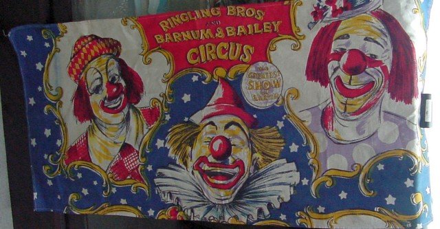 The Greatest Show On Earth Circus Banner: Printed cotton, full title of Ringling Bros Barnum & Bailey Circus, The Greatest Show on Earth, with numerous clown faces, rich vivid colors, no other markings but likely to be 1950s era. 19 1/2" tall