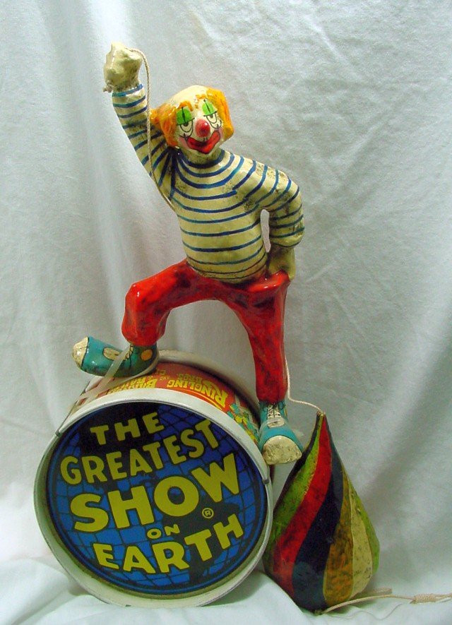 Circus Clown & Top On Drum Toy: Ringling Brothers Barnum & Bailey The Greatest Show on Earth tin decorated drum and a paper Mache clown holding a top attached to the drum, possibly a marriage and possibly original, 15" tall by 7" wi