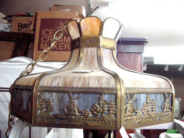 1910 Curved Slag Glass Ceiling Light: Carmel curved glass slag top section to this ceiling light fixture leads down to a blue slag glass band border with a design of windmills and town houses in what is called filigree design for the edge
