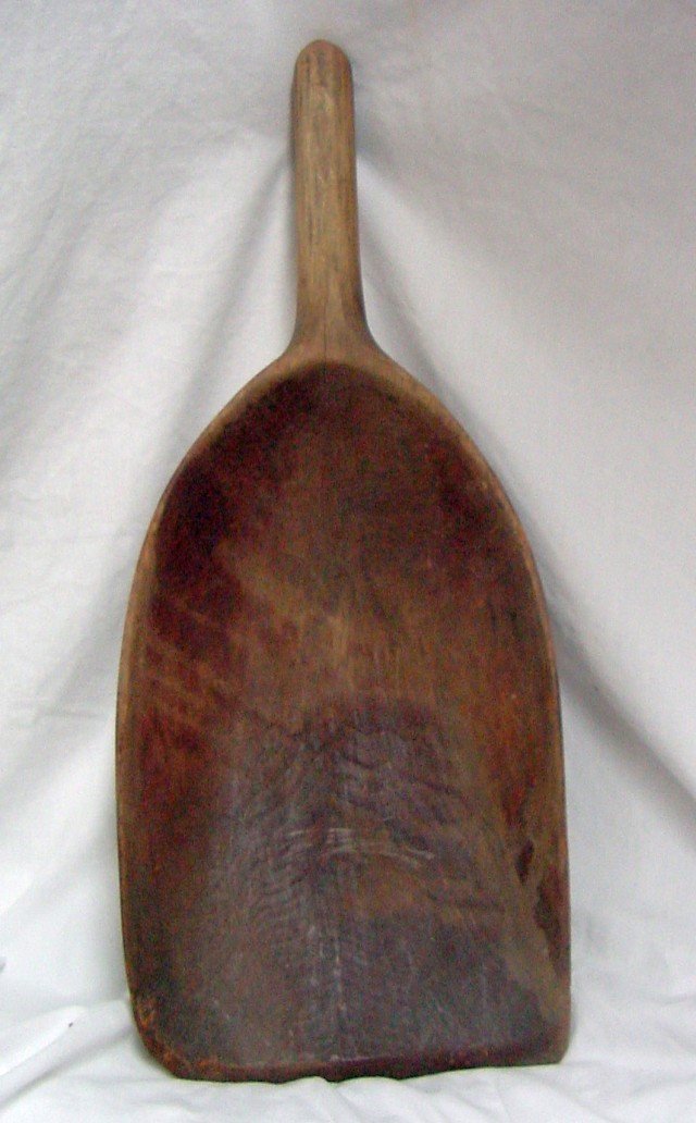 Primitive Handmade Wooden Shovel: The planer marks are clearly visible as are the chisel markings, made from 1 solid piece of wood, a few age splits on edges and corners, there is a hook on the top of the handle for hanging, 18 1/2" l