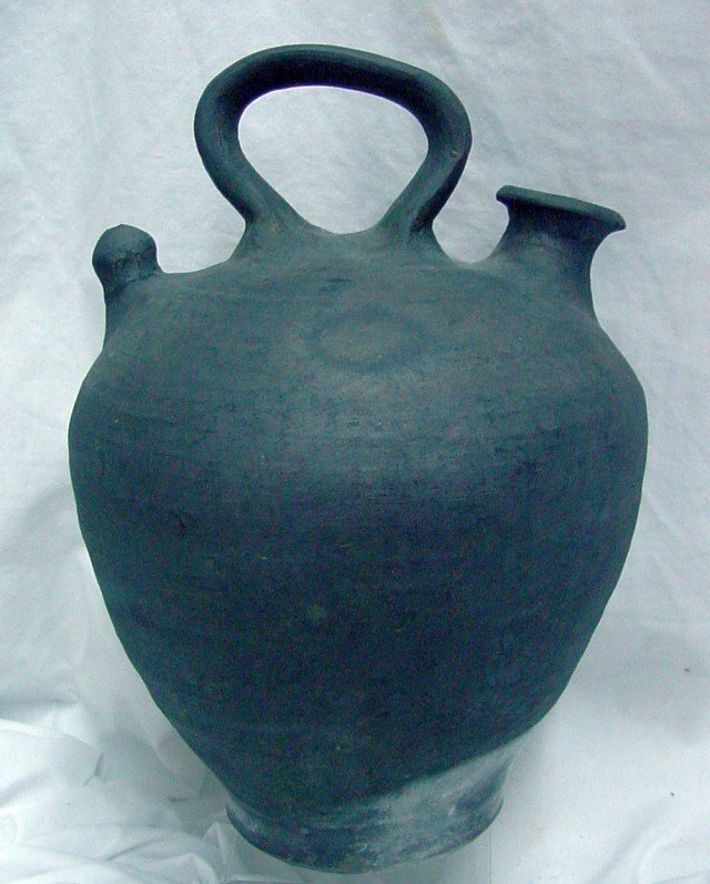 Charcoal Pottery Jug: Unsigned, possibly Native American, center handle, pouring spout, hand made, probably 1920s or 30s era, 12" to the top of the handle, 7" wide.