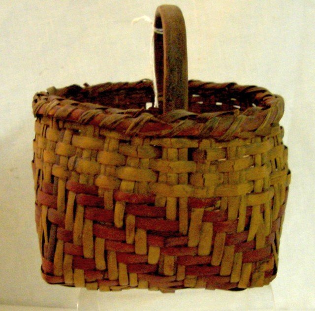Cherokee River Cane Basket w/Handle: Unsigned but originally from the Qualla Cooperative, probably dating to the 1940s close to a miniature size, close to 4 1/2" square on the base by 5 1/2" tall to the top of the handle, red dye on the