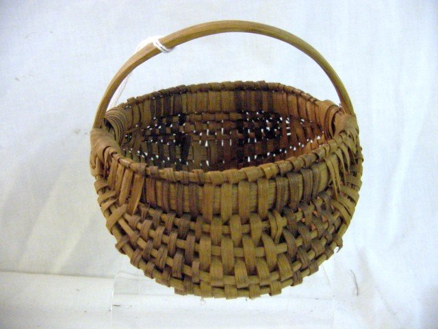 Cherokee Split Woven Miniature Egg Basket: Unusual small size for a Cherokee basket, woven splits, almost gizzard shape, mint condition, Oak handles, 5" wide and long by 4 1/2" tall. There is a band of a purple dye on the splits.