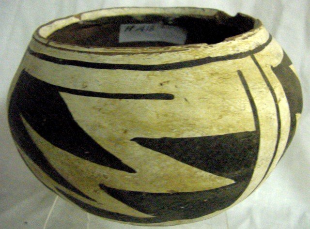 American Indian Southwestern Pottery Bowl: White background and black saw tooth designs, chips to the rim, 6 1/2" wide by 3 1/2" tall.