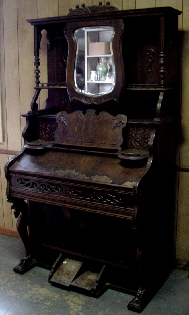 Oak Pump Organ Ca. 1900: Beckwith Organ Co. of Chicago, Ca. 1900, Oak with Oak veneer, some of which is peeling, good shaped beveled mirror, 25" deep, 42" wide by 6 1/2 feet tall. Structurally sound condition.
