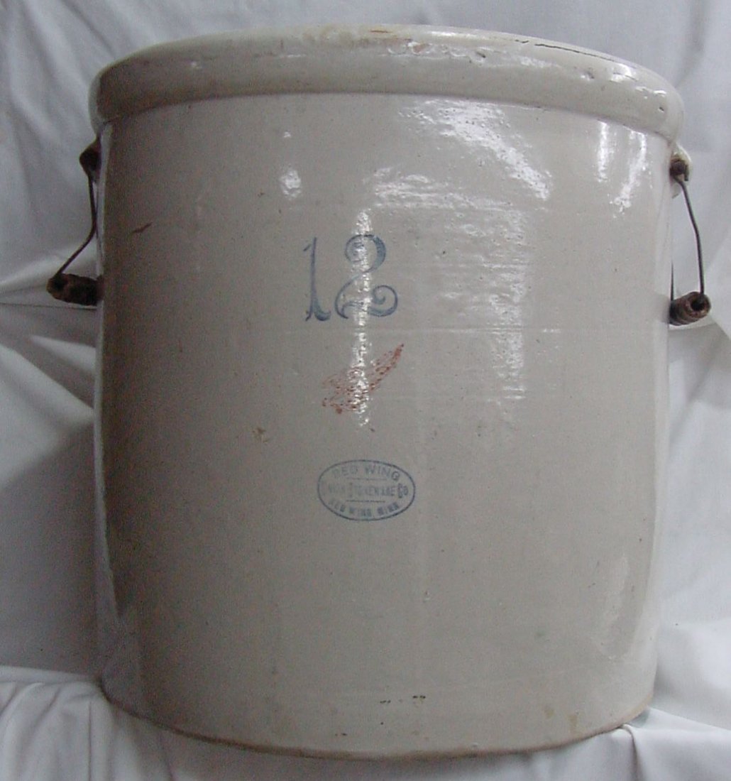 12 Gallon Red Wing Crock Glentonian Bar: Grandmother made pickels in this 12 gallon Red Wing crock in her Glentonian Bar in Lock Haven, Pa., wire handles on the side, there is an age crack in the center of the bottom, otherwise good conditio