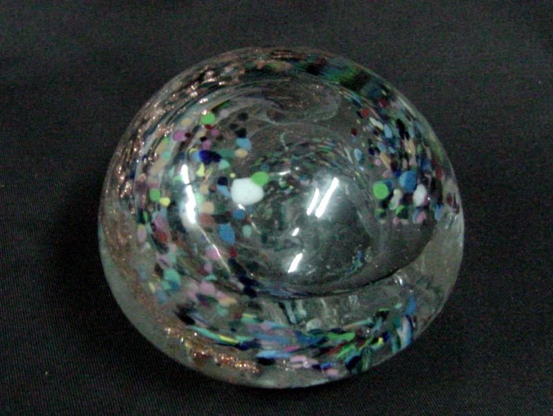 1920s Hand Blown Paperweight: Pontil marking on the base, the interior is a clear glass with a swirl clearly visible, multi colored dots are visible and what appears to be either gold or copper flecks of metal are in the swirl as 