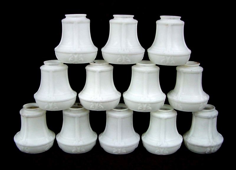 12 Satin Glass Panel & Stylized Band Shades 2 1/4": Matched set of 12, white satin glass, 4 panels with stylized band below each rib on the base, 2 1/4" fitter, 4 1/2" wide by 5" tall. The matched set of 12 is in good overall condition with minor rough