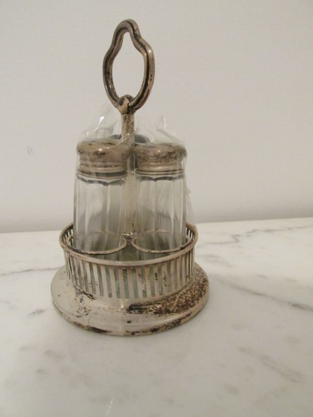 Sterling Silver 1950s Table Condiment Set: Salt & Pepper & Third paneled rib glass holder in a round circular pierced frame with center handle. Marked Sterling, 1950s era, star cutting in the glass of the center of the round holder. 5" tall by