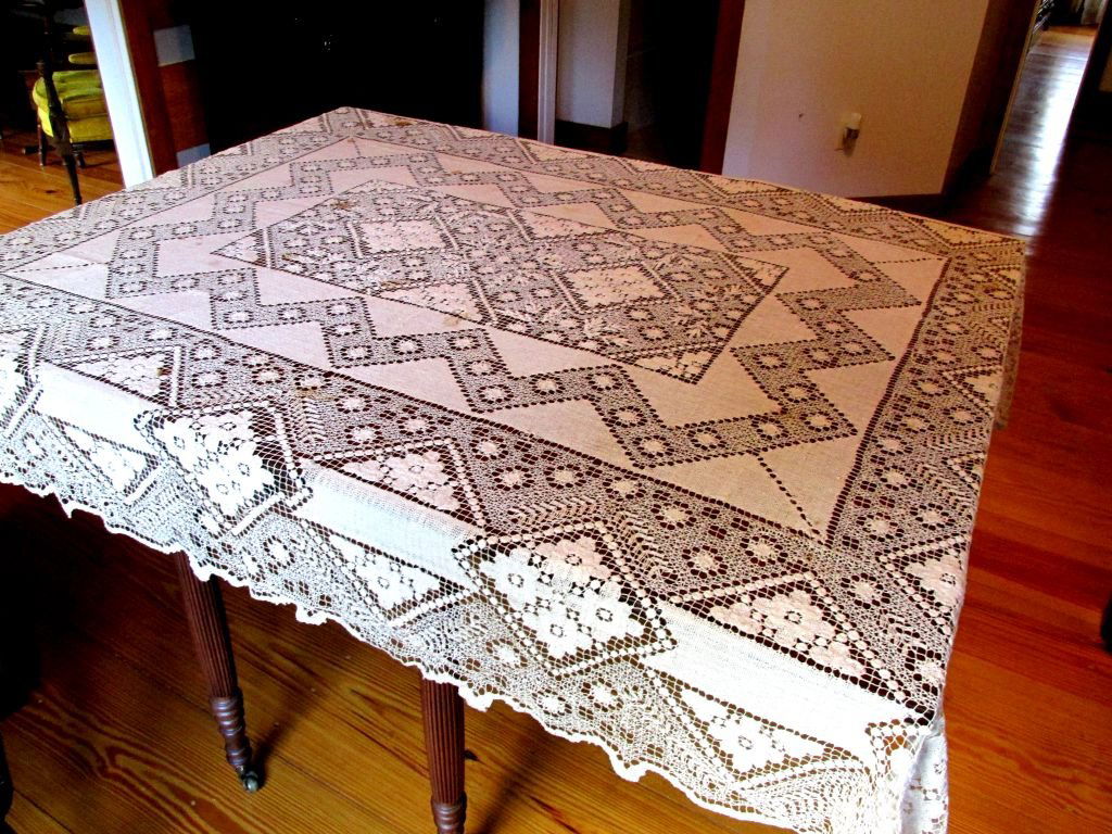 Art Deco 1920s Lace Table Cloth: Aged ivory color, seemingly all cotton, very frilly lace, minor spotting that probably will clean, no visible holes or damages other than minor spotting, a good size for 8 people, good center section