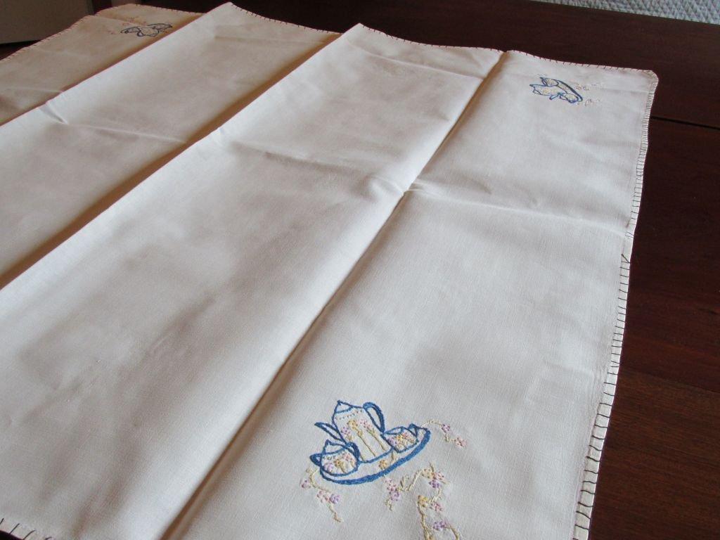 1950s Breakfast Table Cloth w/Embroidered Teapot: Trimmed out in blue around the edges, showing a tea or coffee pot on a tray in the corners with a creamer and sugar, minor losses to a thread or two on the edges that could easily be reattached, pure