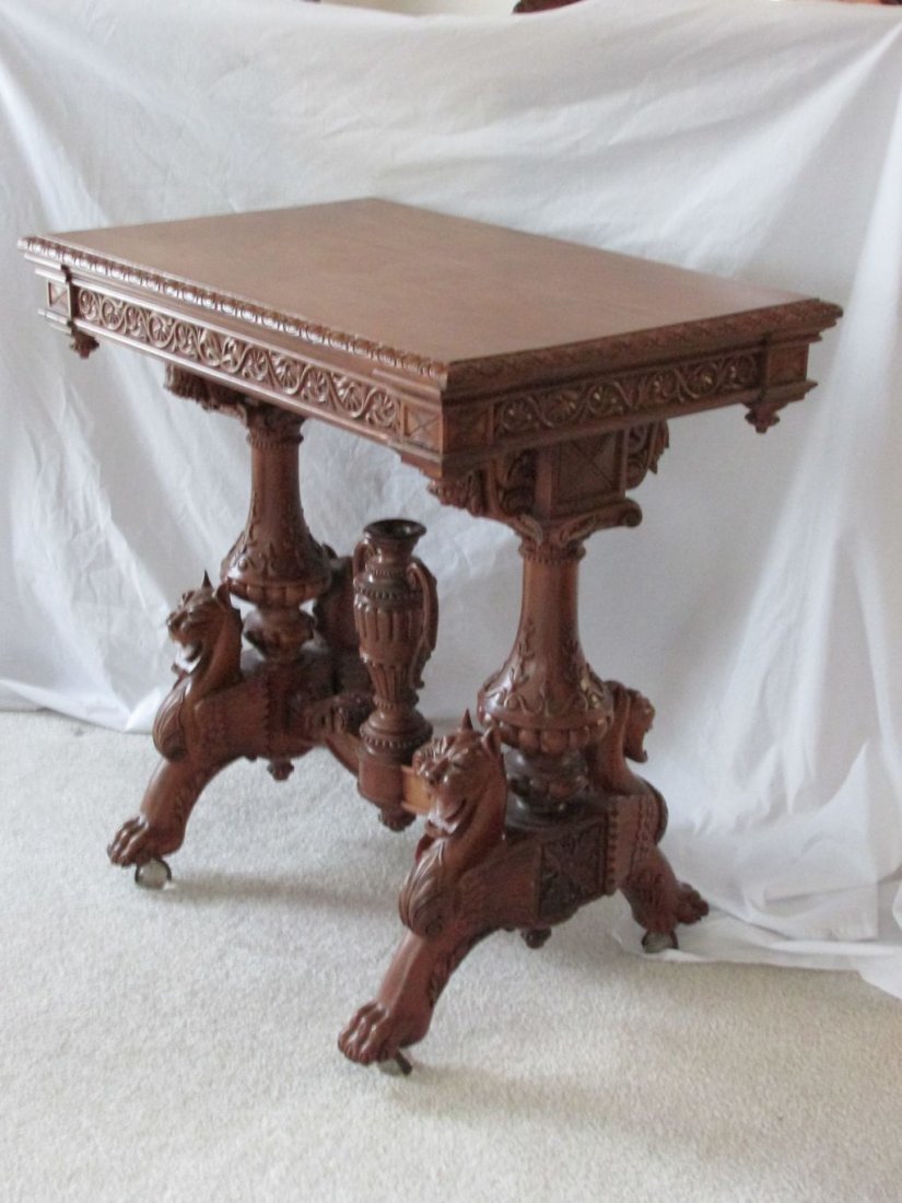 Jelliff? Cherry Carved Table: From winged griffons to a center urn, to a hand carved frieze both on the sides and around the top of the table, even the legs are cameo carved and extremely well done. The wings on the griffons have 