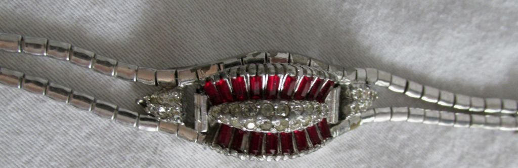 Clarin 50s Fashion Novelty Watch: Highly decorative from the 1950s with ruby baguettes, round faux diamonds on a hinged lid covering the face, white metal bracelet making this actually resemble a fine piece of jewelry as a bracelet. A