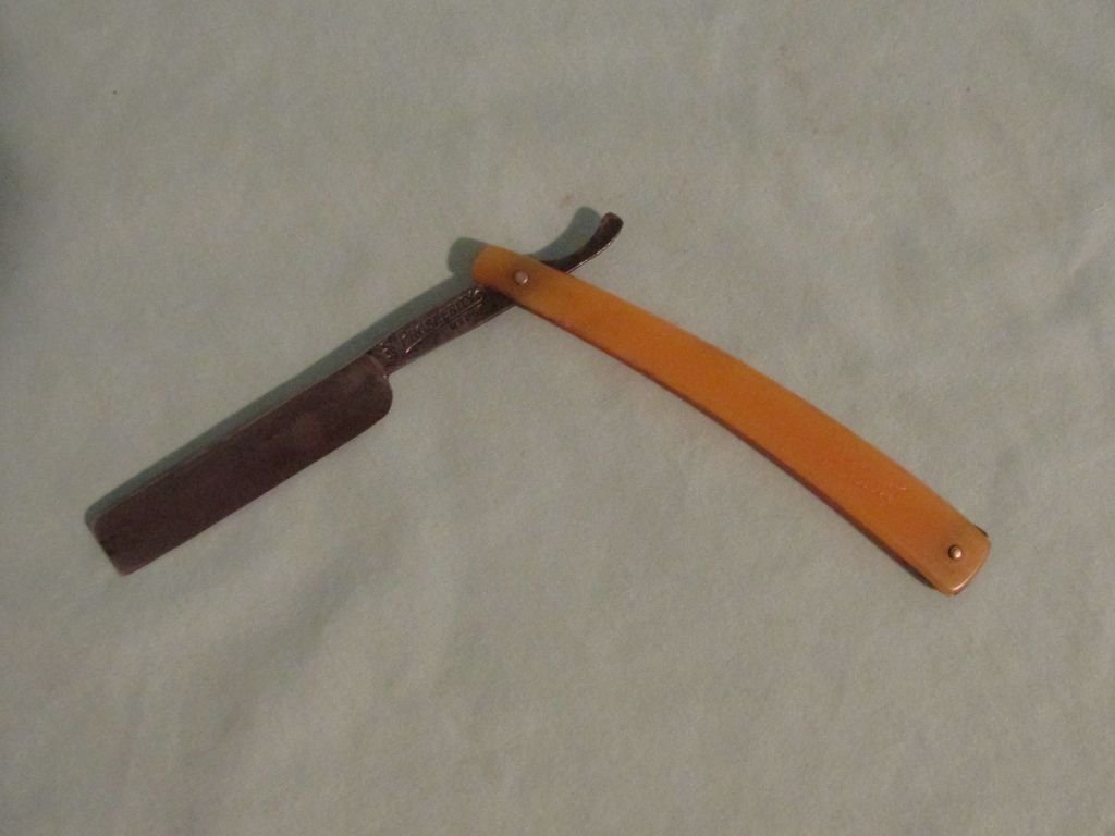 Prosperity Wedge Straight Razor E. Morris MFG. Co.: Ca. 1900-1920 camel color bakelite handle, Prosperity Wedge 400 E. Morris MFG. Co. Detroit, Mich. Made in Solingen closed - 6" : open - 9 1/4"