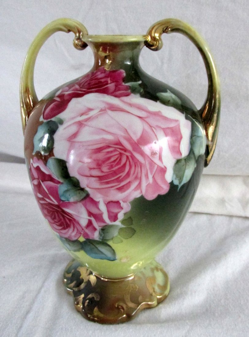Hand Painted Nippon Double Handled Vase: Signed on the base Nippon Hand Painted, pretty lush pink and red roses with green leaves, double handles trimmed in gold, looks in time to be 1900-1920 with heavy Art Nouveau influences. 6" tall by 6"